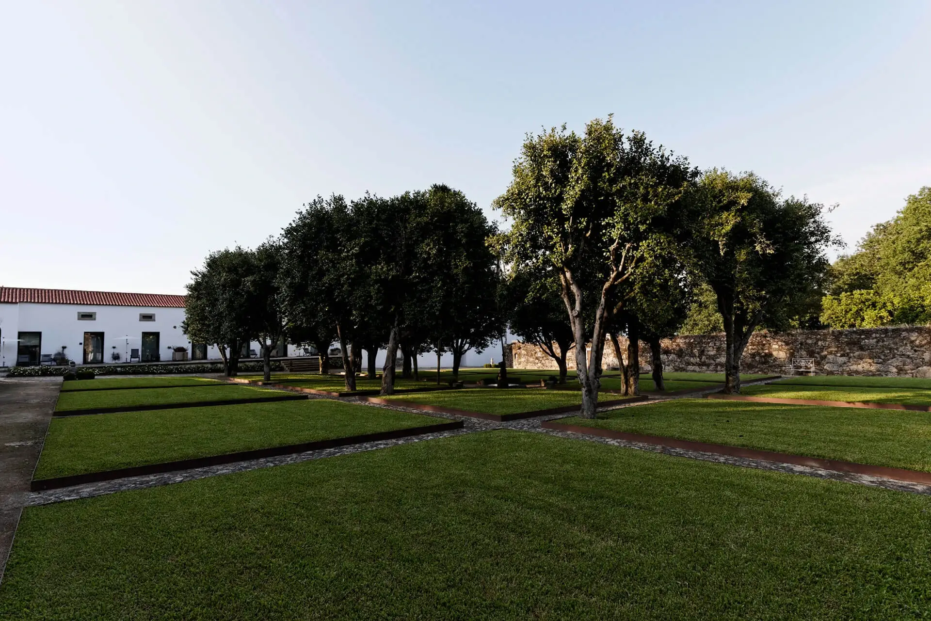 Lawn and centenary trees in the gardens of Paço do Vitorino